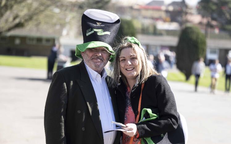 A couple celebrating St Patricks Day at the races.